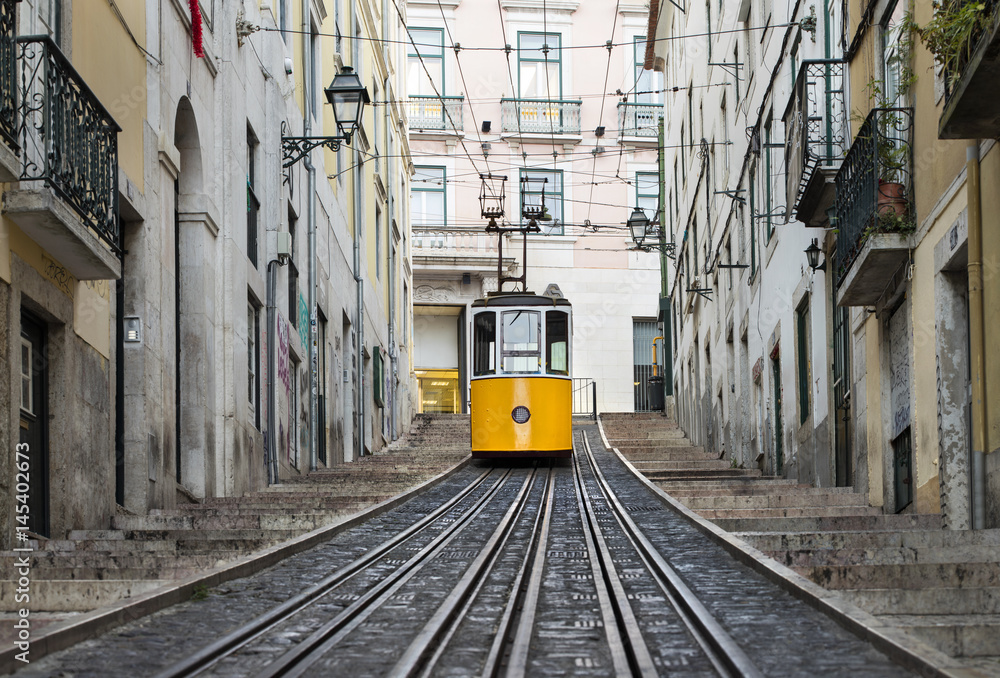 railway and lonely yellow tram in Lisbon in Portugal