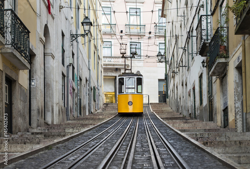 railway and lonely yellow tram in Lisbon in Portugal