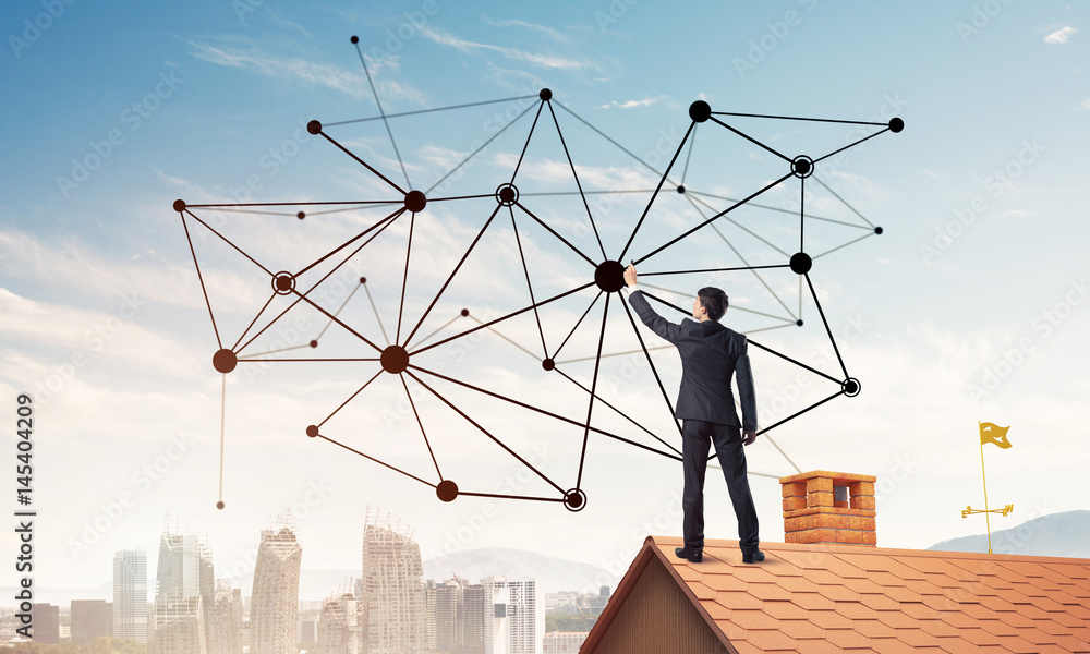 Businessman on house roof presenting networking and connection c