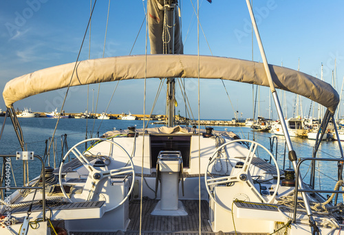 Sailing boat on a calm sea under blue sky