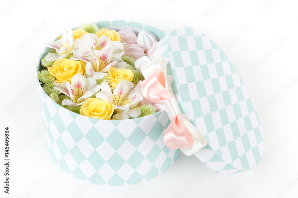 Round box with fresh flowers and meringue cookies isolated on white background Round box with fresh flowers and meringue cookies isolated on white background