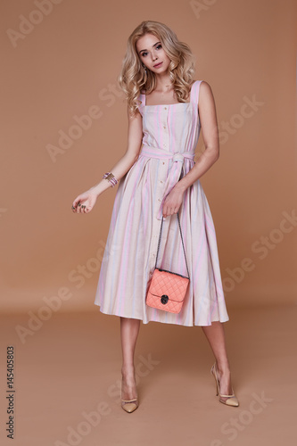 Beauty woman model wear stylish design trend clothing cotton dress casual formal office style for date walk meeting walk party long blond hair lips makeup party businesswoman accessory bag fashion.