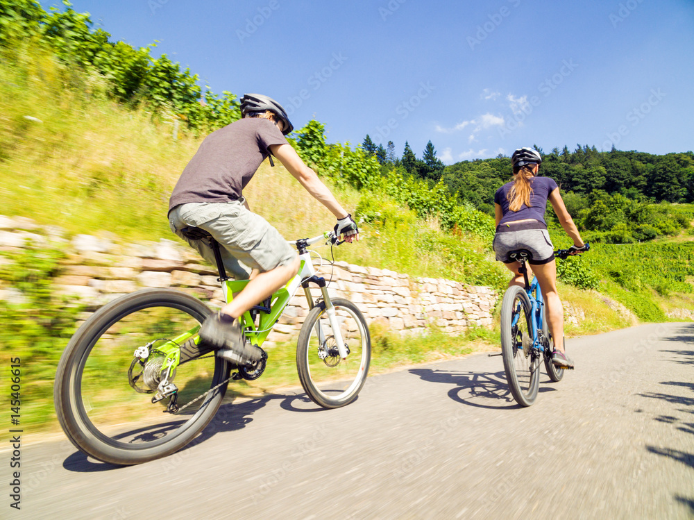 Young Couple Riding Their Mountain Bikes