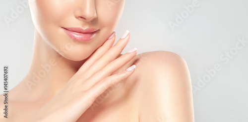 Tableau sur toile Beautiful Young Woman with Clean Fresh Skin  touch own face