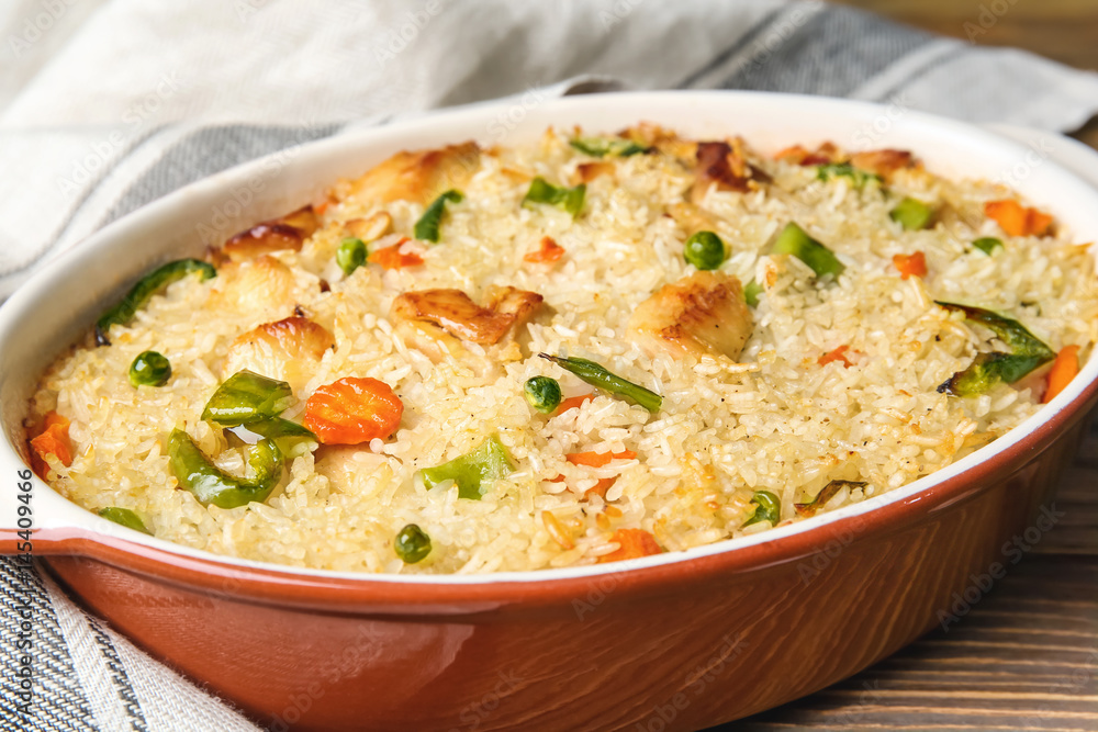 Tasty rice and chicken with vegetables in baking dish Tasty rice and chicken with vegetables in baking dish