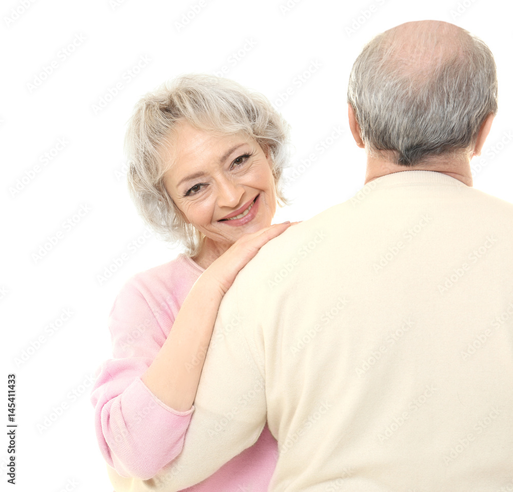 Happy senior woman embracing her husband on white background Happy senior woman embracing her husband on white background