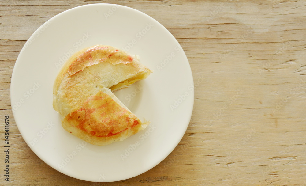 Chinese cake filled mushed bean and salty egg cut for pieces on plate Chinese cake filled mushed bean and salty egg cut for pieces on plate