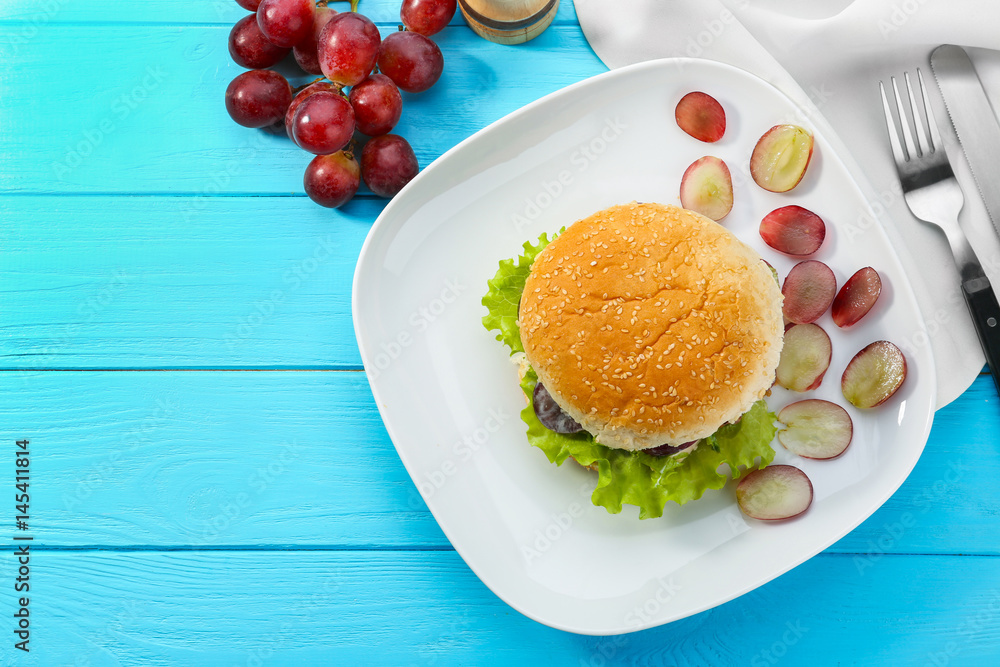 Plate with chicken salad in burger bun on  table