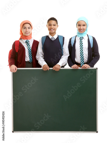 Schoolchildren with green s...