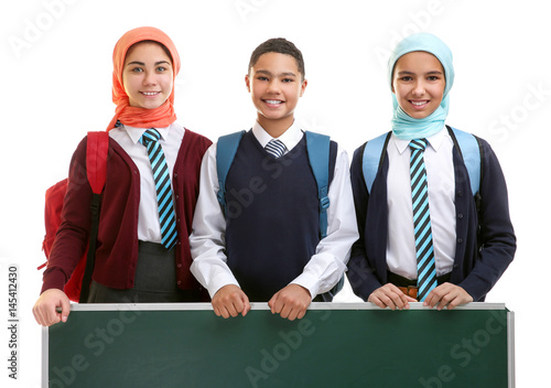 Schoolchildren with green s...
