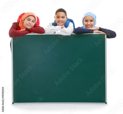 Schoolchildren with green s...