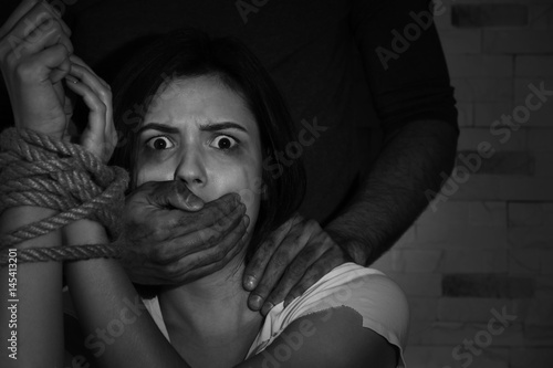 Photo Young woman with tied hands subjected to violence, closeup