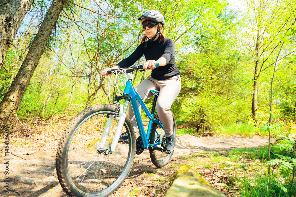 Fototapeta premium Young Woman Riding Her Mountain Bike