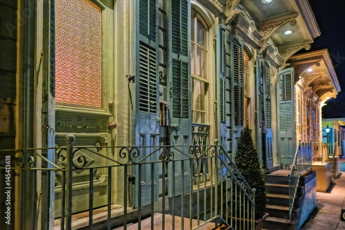 A colorful facade, entry doors in a row, and porches in The French Quarter of New Orleans. photo