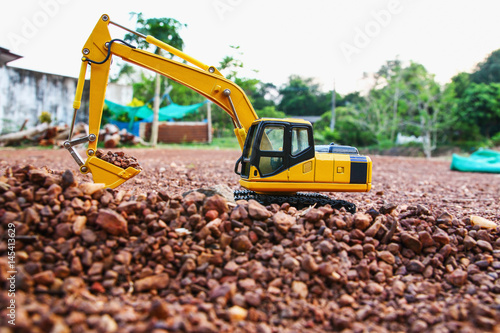 Excavator loader model on ground and  are digging stone