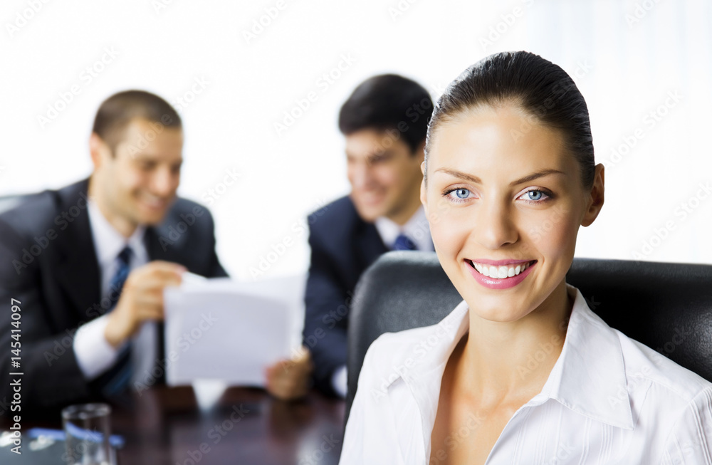 Businesswoman and colleagues, at office Businesswoman and colleagues, at office