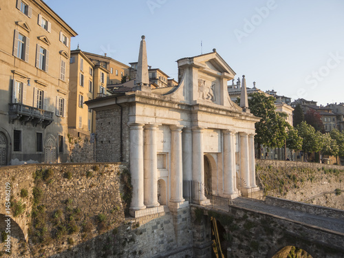 Bergamo - Old city (Città Alta). One of the beautiful city in Italy. Lombardia. Landscape on the old gate named Porta San Giacomo during the sunrise and a wonderful blu day