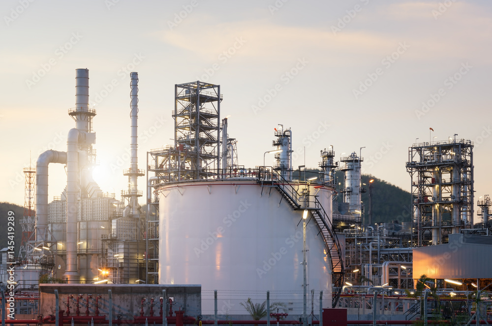 Natural Gas storage tanks and oil tank in industrial plant at twilight