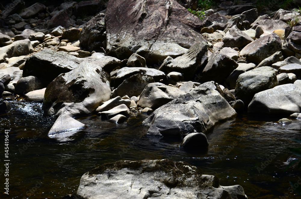 Fototapeta premium River passing through rocks