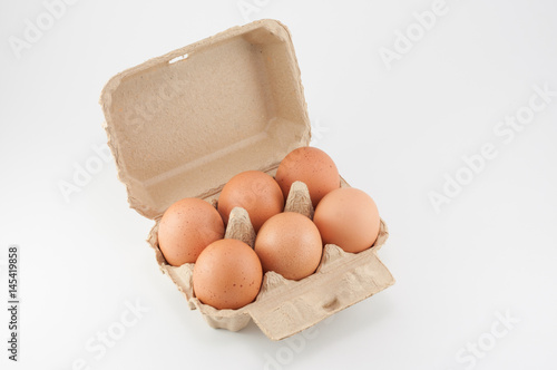 Egg box - eggs in an egg carton on white background photo