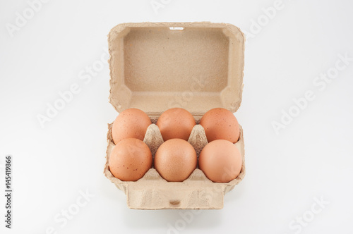 Egg box - eggs in an egg carton on white background