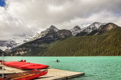 Canoeing at Lake Louise, one of the most beautiful alpine lakes in the Canadian Rockies, famous for the green-blue color of the water. 