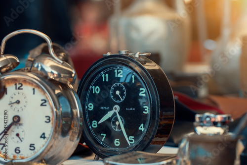 Fotografija retro alarm clocks on counter in sunday flea market