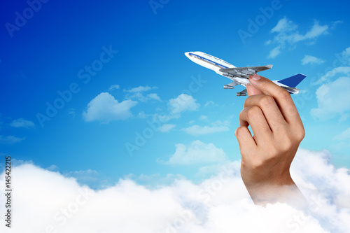 hand holding airplane isolated on white, travel concept