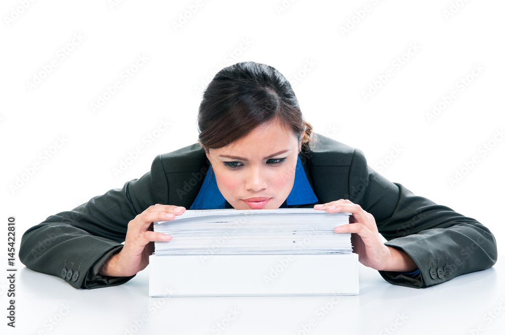 Stressful young woman with head resting on pile of documents over white background Stressful young woman with head resting on pile of documents over white background