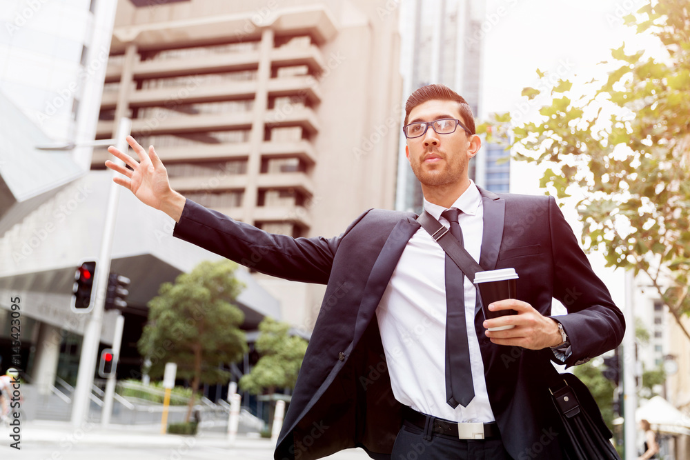 Young businessmen hailing for a taxi Young businessmen hailing for a taxi