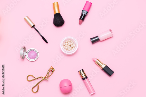 Makeup brush and pink cosmetics. flat lay