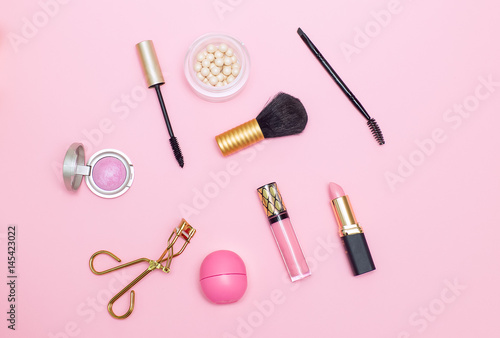 make up products pink background. Flat lay
