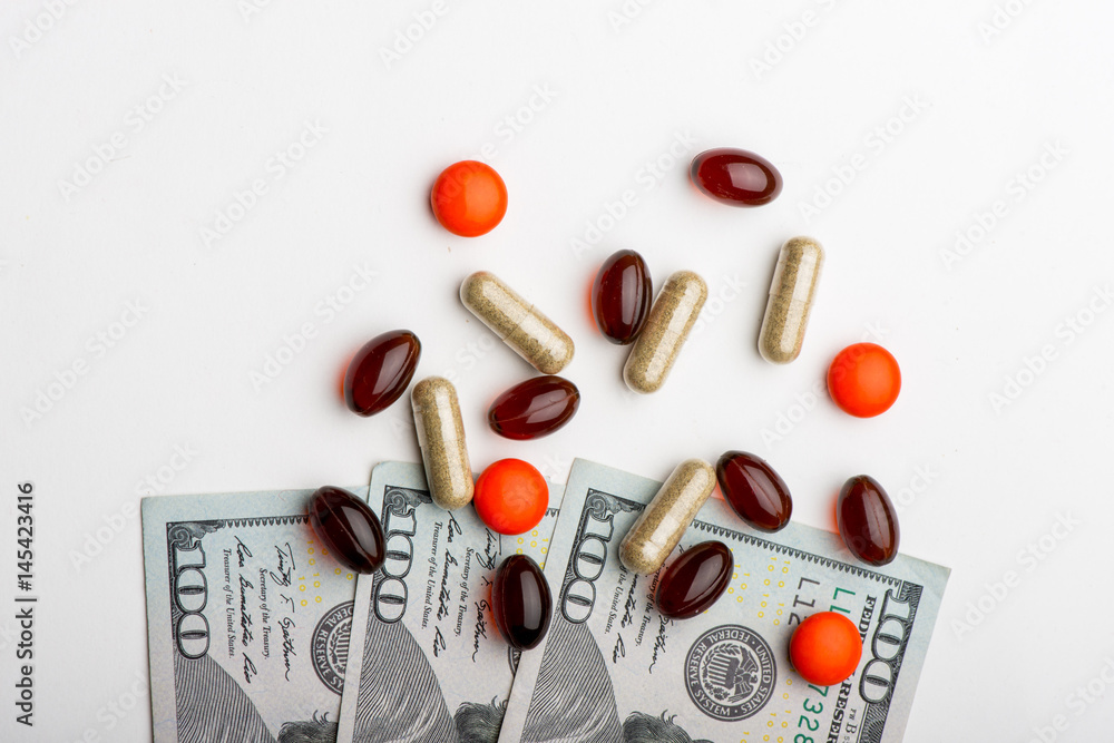 Pills with money on white background Pills with money on white background