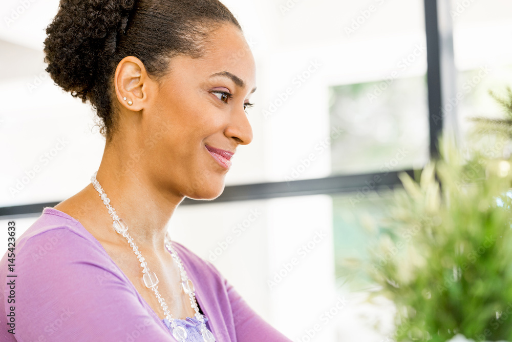 Portrait of smiling afro-american office worker sitting in offfice Portrait of smiling afro-american office worker sitting in offfice