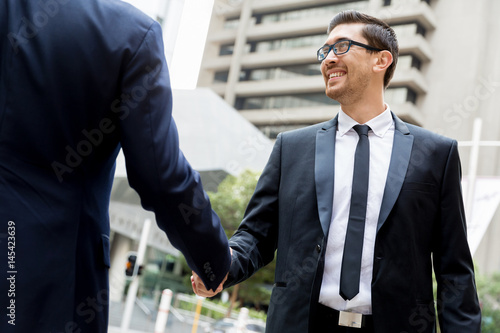 Two businessmen shaking their hands