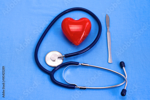 Uniform surgeon with stethoscope, heart and pills