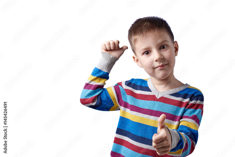 Cute European boy is showing thumb up gesture. At the same time he is pointing to background with the other hand thumb. He is smiling and looking in the camera. Isolated on white. Cute European boy is showing thumb up gesture. At the same time he is pointing to background with the other hand thumb. He is smiling and looking in the camera. Isolated on white.