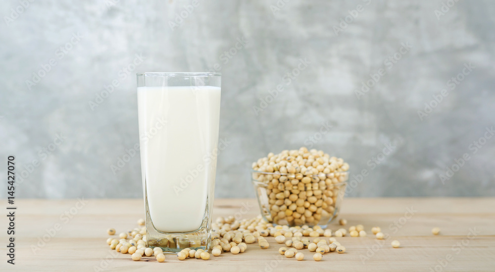 soybean in a bowl and soy milk on a wooden background. soybean in a bowl and soy milk on a wooden background.