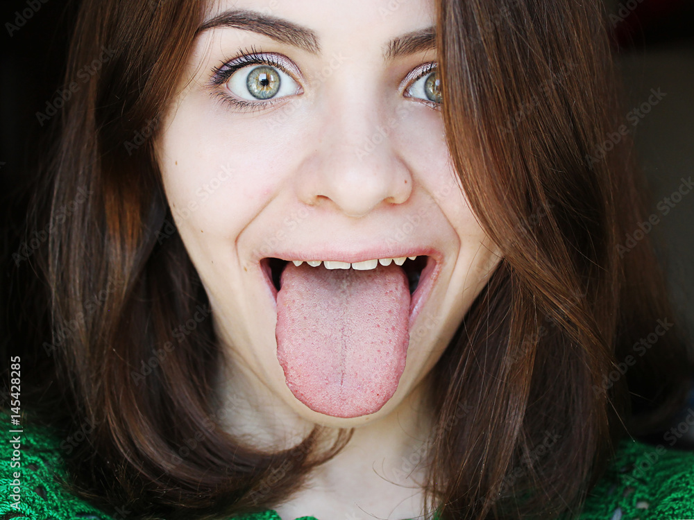 Fototapeta premium Attractive girl showing a healthy tongue 