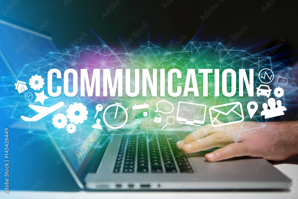 Concept of man holding a futuristic interface with communication title and multimedia icons flying all around - Internet concept Concept of man holding a futuristic interface with communication title and multimedia icons flying all around - Internet concept