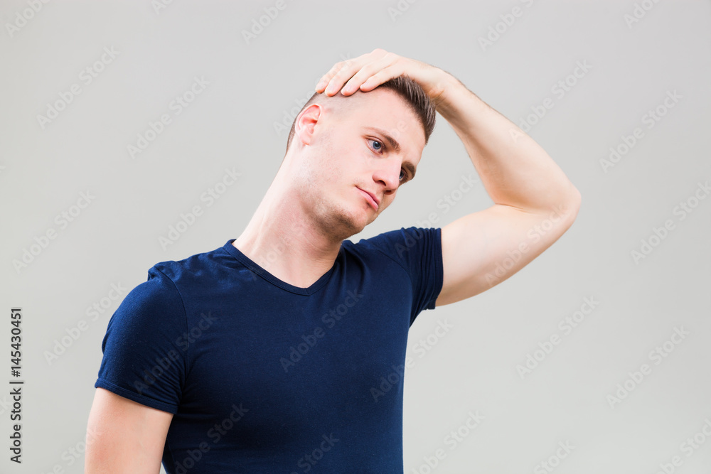 Studio shot image of young man who is stretching his body. Studio shot image of young man who is stretching his body.