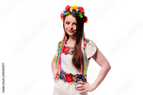 Girl in Ukrainian national traditional costume holding her flower chaplet - isolated on white