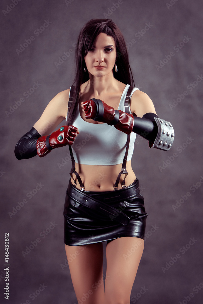 Young woman posing as superhero or superwoman Young woman posing as superhero or superwoman