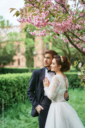 Wedding in park cherry blossom bride groom