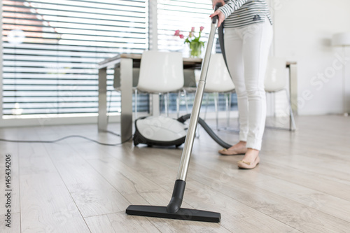 Attractive Female with Vacuum Cleaner