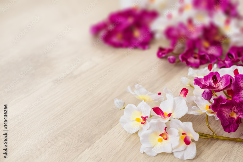 White and purple orchids on wooden surface White and purple orchids on wooden surface