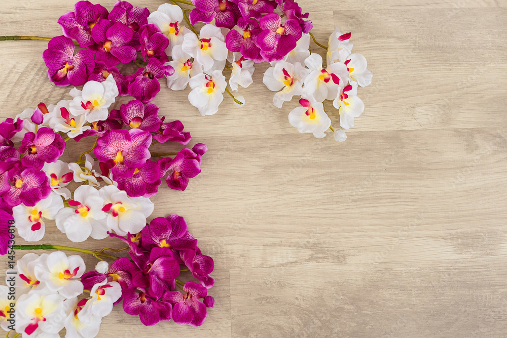White and purple orchids on wooden surface