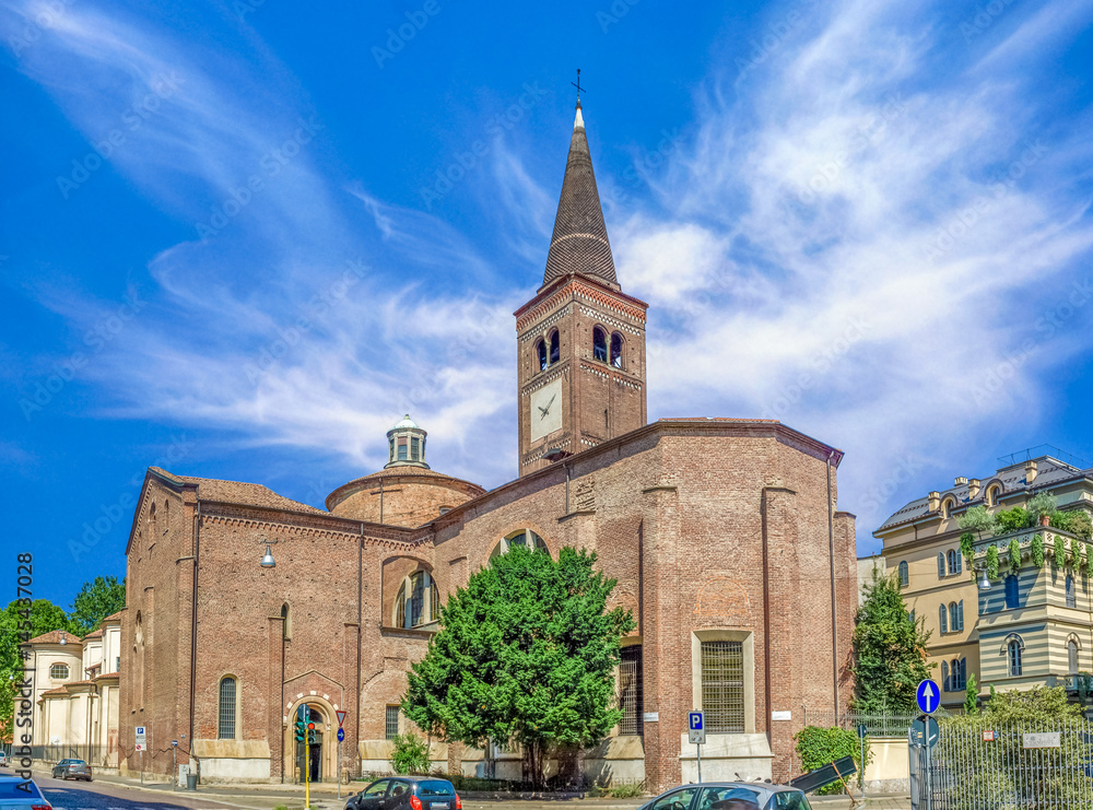 Side view of Church of San Marco in Milan, Italy. Dedicated to St. Mark. Beautiful wide angle picture with colorful blue sky and white clouds