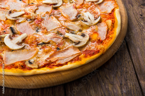 Delicious pizza with mushrooms and smoked chicken