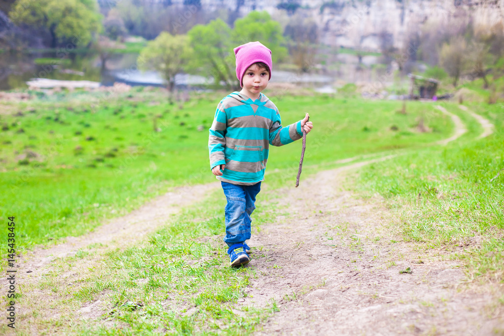 A boy walks through a meadow. A boy walks through a meadow.